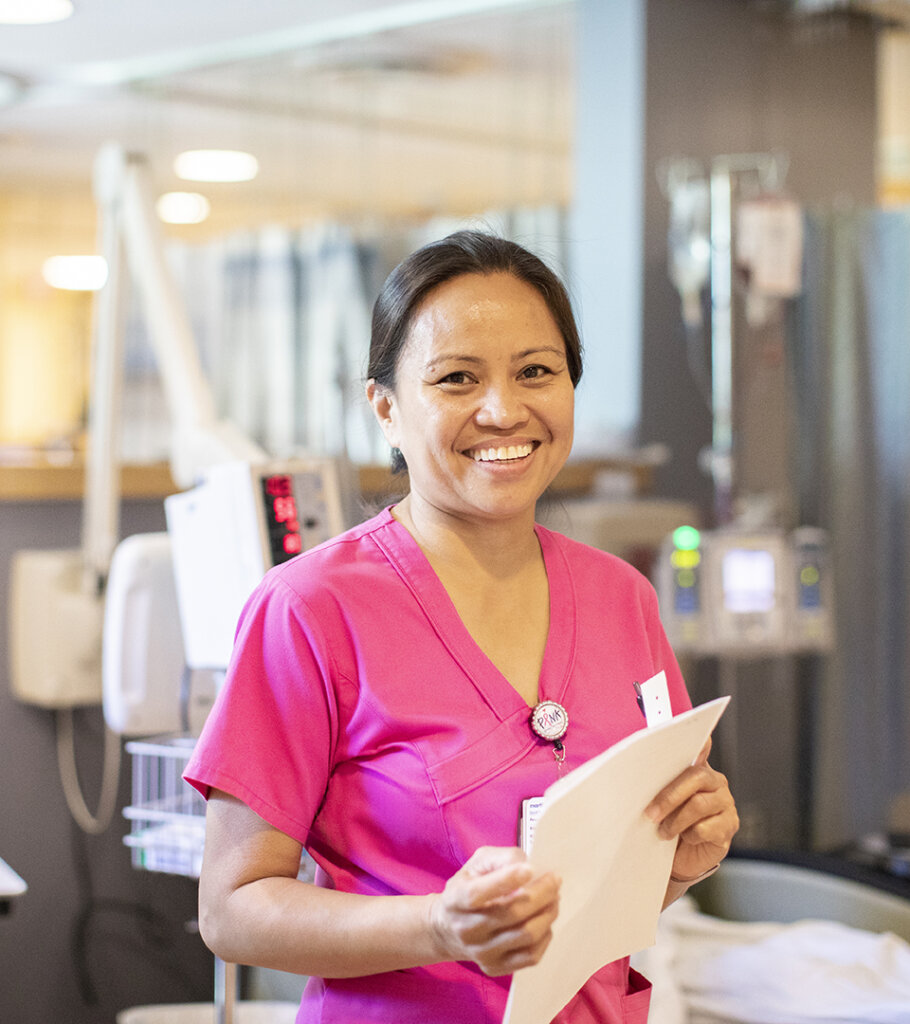 Asian American medical professional in a hospital setting smiling