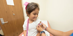 smiling child after getting a vaccine