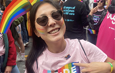 Academic research specialist Liana Beld models the UCSF Pride progress pin at the San Francisco Pride Parade 