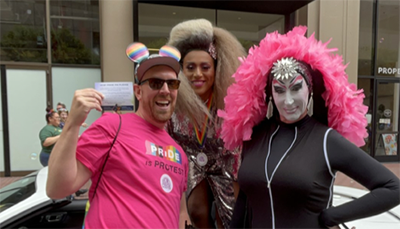 Graham Hinchcliffe gives UCSF Pride Pin Pledges to Honey Mahogany and Sister Roma at the San Francisco Pride Parade.