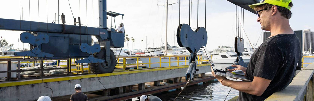 Marcus Lehman stands at the dock as the xWave is lowered into the water