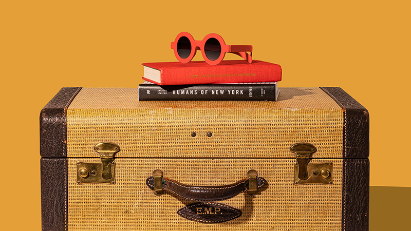 Vintage suitcase, books and sunglasses