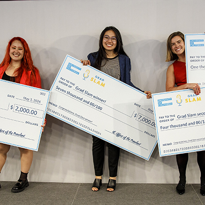 Cashing in some giant checks, from left to right, third-place winner Shannon Brady of UC Riverside; first-place winner Iris Garcia-Pak of UC San Diego; and Kacie Ring of UC Santa Barbara, who won second place and the People's Choice award.