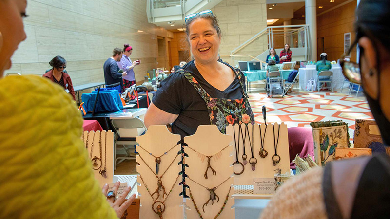 Brandee Woleslagle Blank (center) displays her homemade jewelry and crafts. 