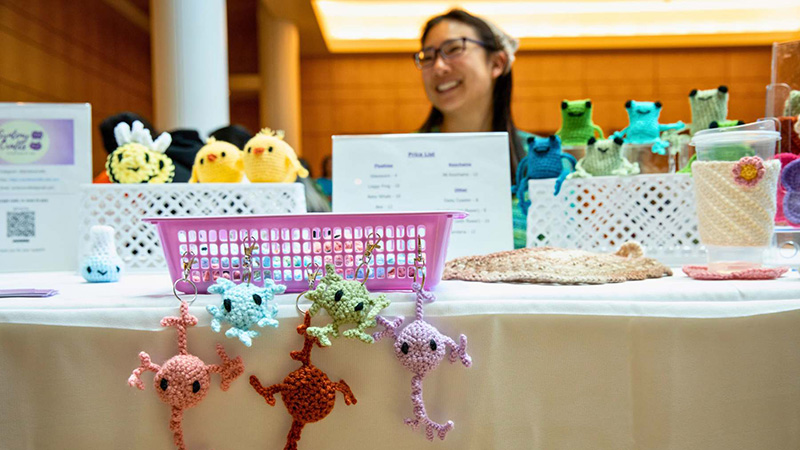 Iris Chin, a graduate student in the Biomedical Sciences program, sells her crocheted items at the Spring Handmade Market hosted by the Artisan Guild By The Bay in Genentech Hall at the UCSF Mission Bay campus in San Francisco, CA on Tuesday, May 7, 2024.