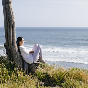 Student sitting by the ocean at UC Santa Barbara
