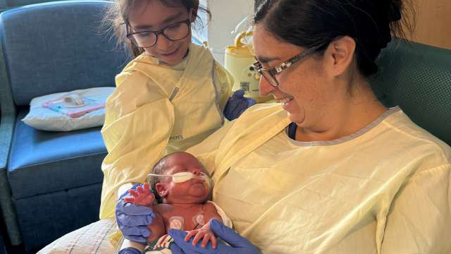 Mom Eliana Cantu and her daughter, Marleen, visit with baby Ian