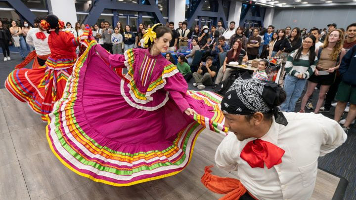 Latinx dancers in colorful costumes