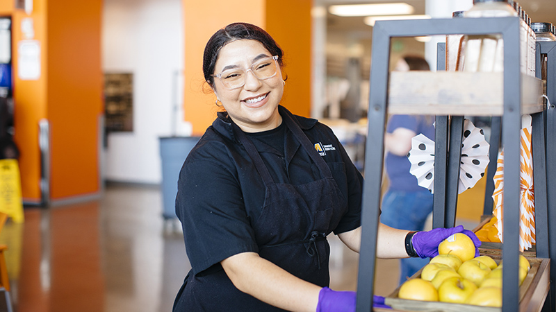 Woman working in a dining hall at UC Merced