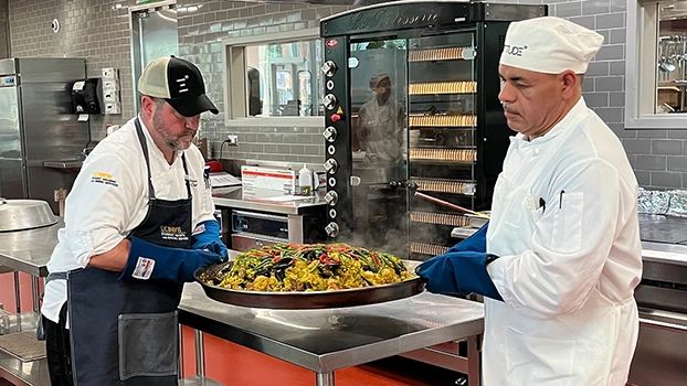 Roger Thompson and Elias Uribe make paella