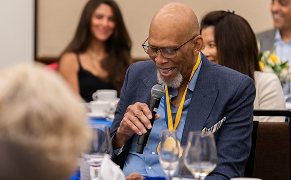 Kareem Abdul-Jabbar holding a microphone