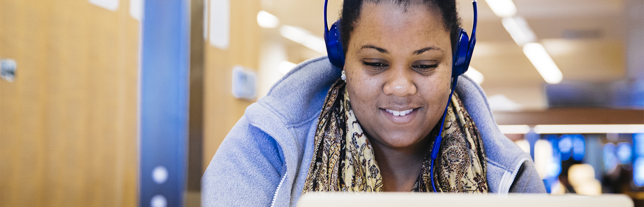 Person on laptop wearing headphones