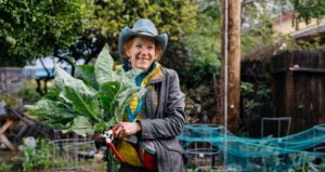 Smiling older person in a garden.