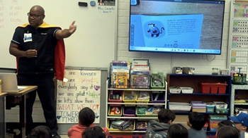 Santiago talking to a room of children