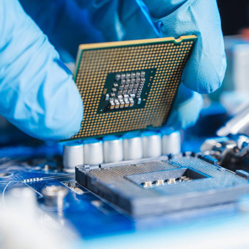 Gloved hand holding a microchip