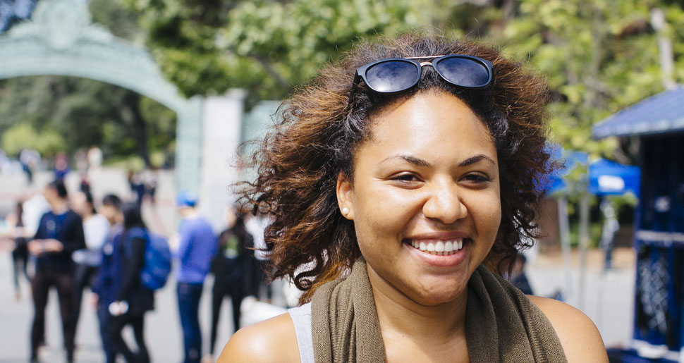 Smiling woman walking on the UC Berkeley campus