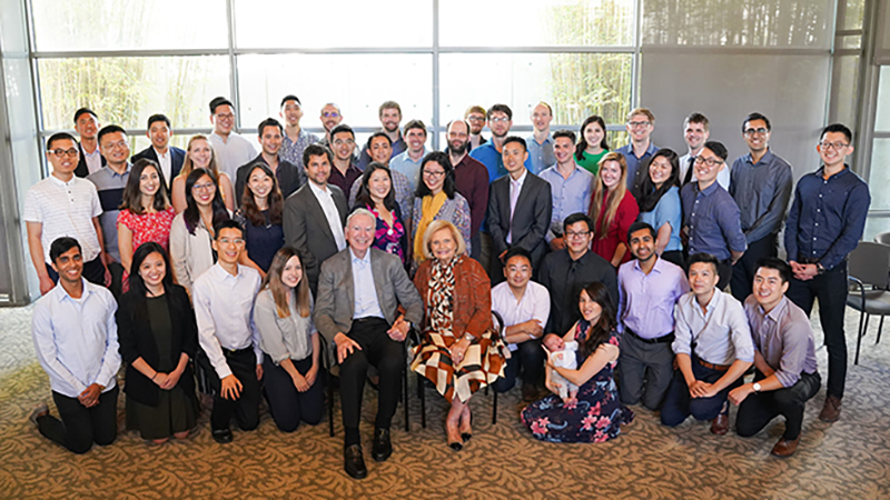 At front center, Joan and Irwin Jacobs at a 20th celebration of the Jacobs Scholars and Fellows Program, in 2019.