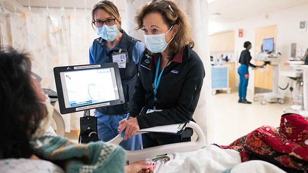 Trese Biagini, NP, left, and Kathleen Kinda, NP, nurse practitioners in the UCSF Neurovascular Service, take care of a patient in the Emergency department at UCSF Medical Center at the Parnassus Heights campus. Photo by Susan Merrell