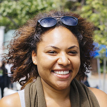 Smiling woman walking on the UC Berkeley campus