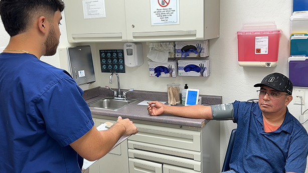 A volunteer medical student helps a patient at Clínica Tepati — the free clinic affiliated with the UC Davis School of Medicine.