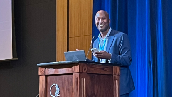 Van Williams stands at a podium during the UC AI leadership event, Jan. 2025