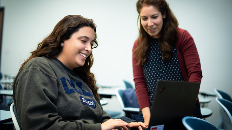 Antonia Osuna-Garcia, right, helps a student with research.