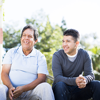 Older and younger man conversing