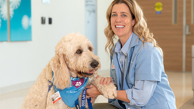 Bob Barker, a member of the pet therapy team, with Emily Longhurst