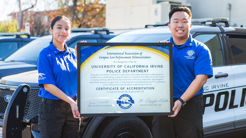 Community safety ambassadors proudly display the IACLEA certificate of accreditation for the UC Irvine Police Department.