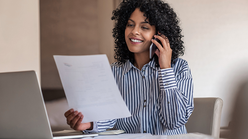 Woman talking on the phone about a paper she's holding