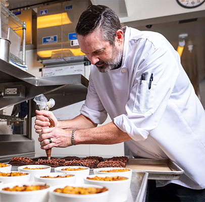 Chef Hayden Dozier in the kitchen at The Club & Guest House