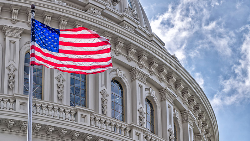 Washington DC Capitol dome detail with waving American flag