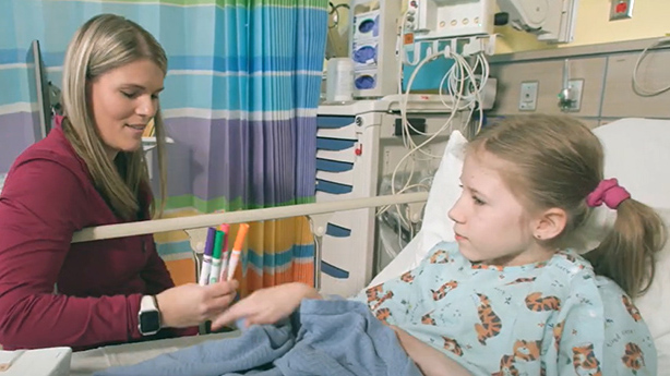 Staff person talking to young girl