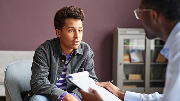 Pre-teen boy speaking with psychologist