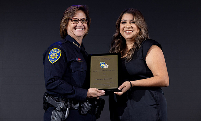 UC Irvine Police Department Chief Liz Griffin presents the Professional Staff of the Year award to Monique Contreras ’22, property and evidence analyst and court liaison.