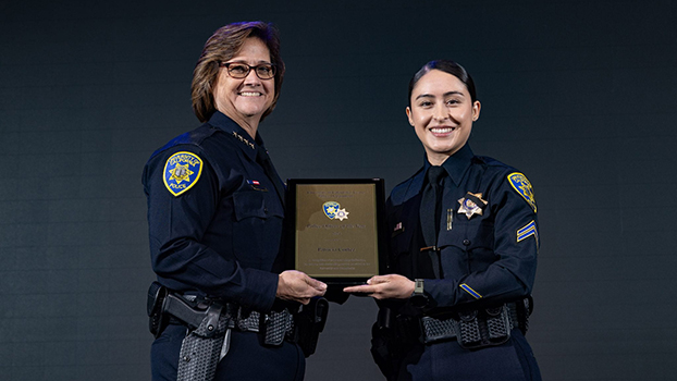 UCIPD Chief Liz Griffin presents the Police Officer of the Year award to Cpl. P. Cortez.