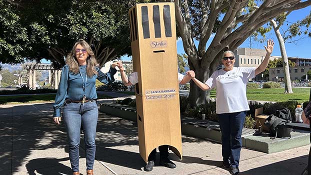 Jen Johansen, left, academic personnel manager in the College of Creative Studies, and Lisa Blanco, right, flank "Storkie" Joshua Mejia-Padilla, financial coordinator in the sociology department.