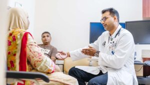 UC Irvine doctor speaks with a patient and her husband