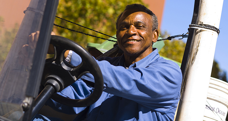 Uniformed worker driving a truck