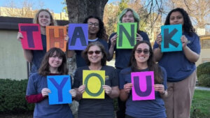 People holding "thank you" sign