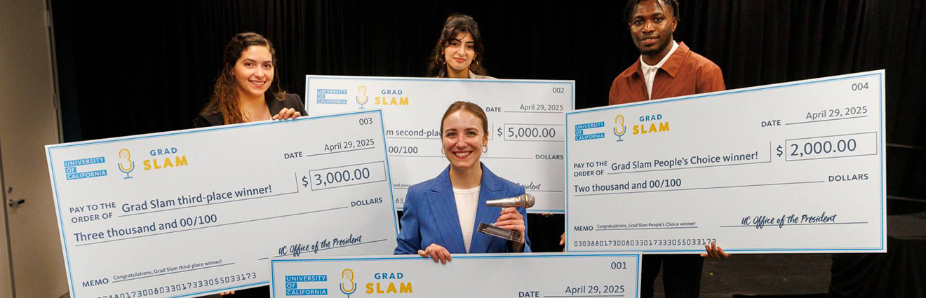 Four winners of UC's grad slam holding large prize checks