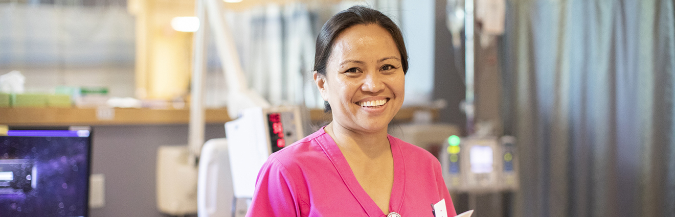 Smiling medical professional in pink scrubs