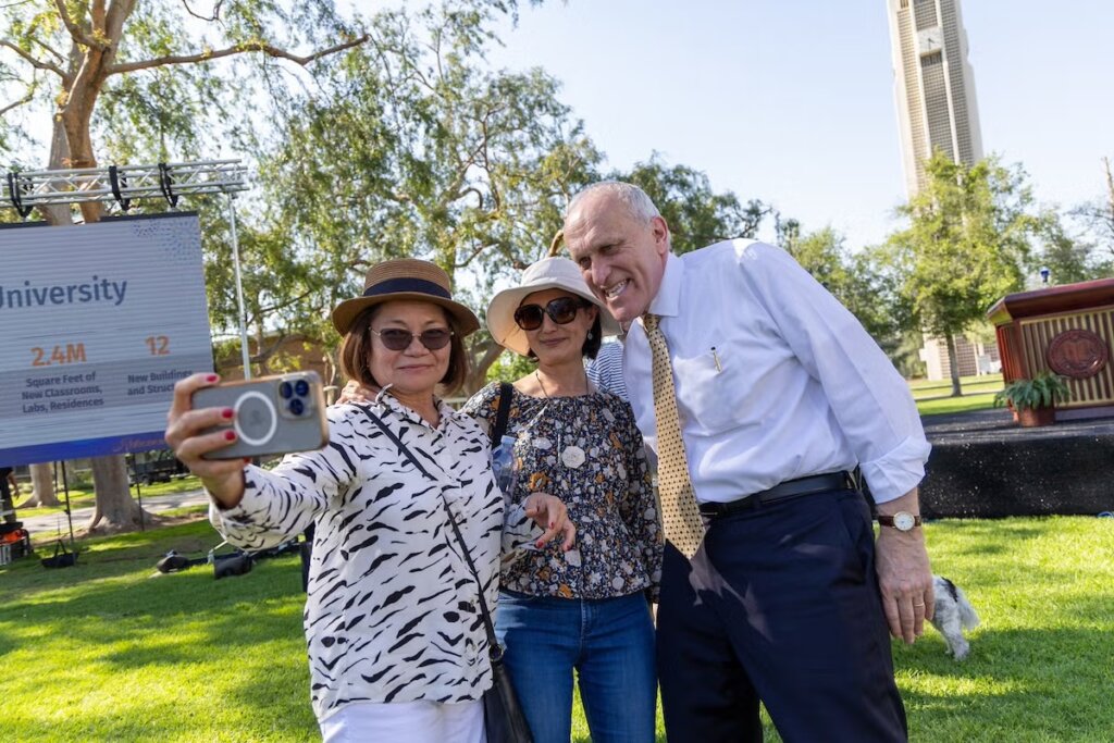 Kim Wilcox (right) poses with staff