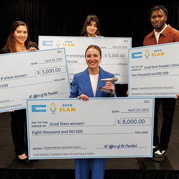 Grad Slam winners holding up giant checks