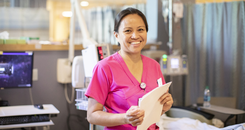 Smiling medical professional in pink scrubs