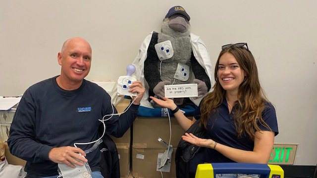 Two people and a stuffed toy gorilla