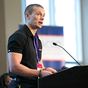 Russell Lehman speaking at a podium