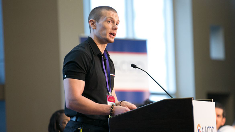 Russell speaking at a podium