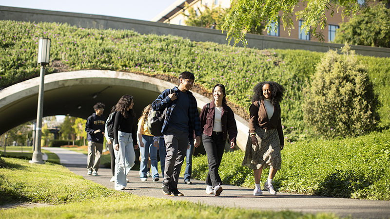 UC Irvine students walking in Aldrich Park