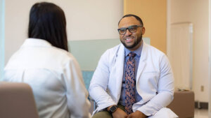 Chris Hall speaking with a patient